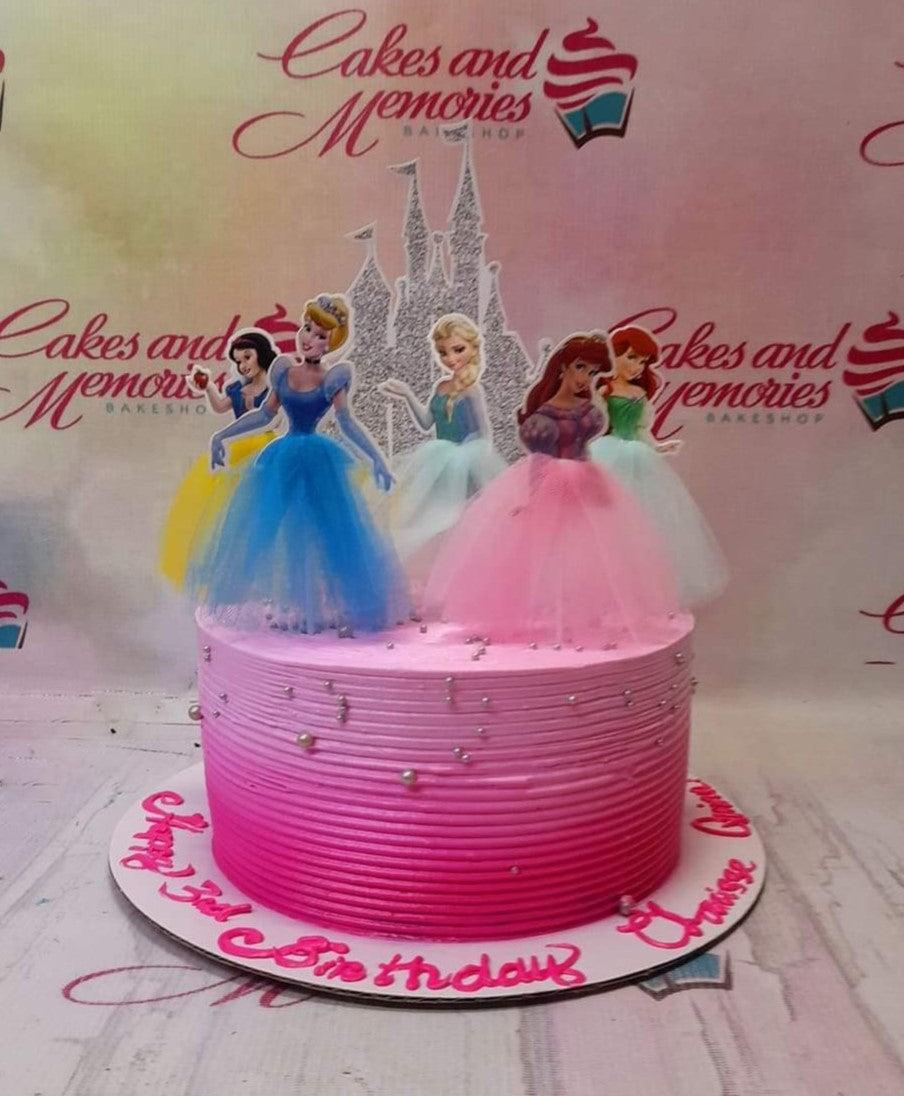 Pink ombre princess cake with Disney princess printouts and silver pearls