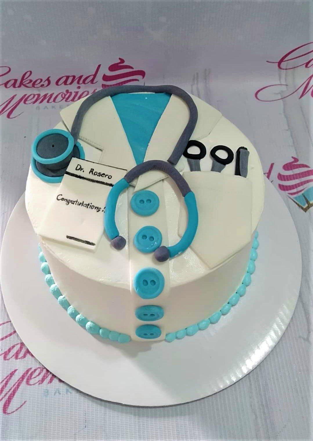 Medical doctor themed cake with white lab coat icing design, blue stethoscope, and personalized name tag for Dr. Rosero.
