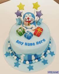 Light blue Doraemon themed birthday cake with a 3D Doraemon figure, colorful gift boxes, and star toppers.