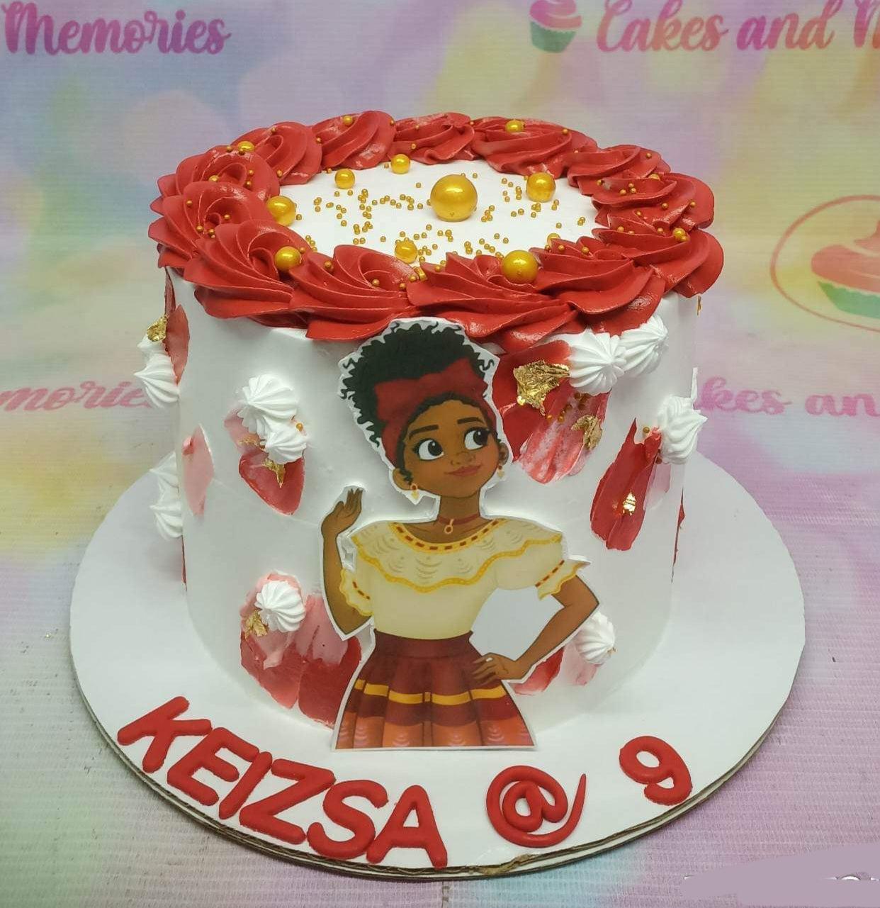 White 1-tier Encanto themed cake with red icing rosettes, gold pearls, and a Dolores Madrigal character printout.
