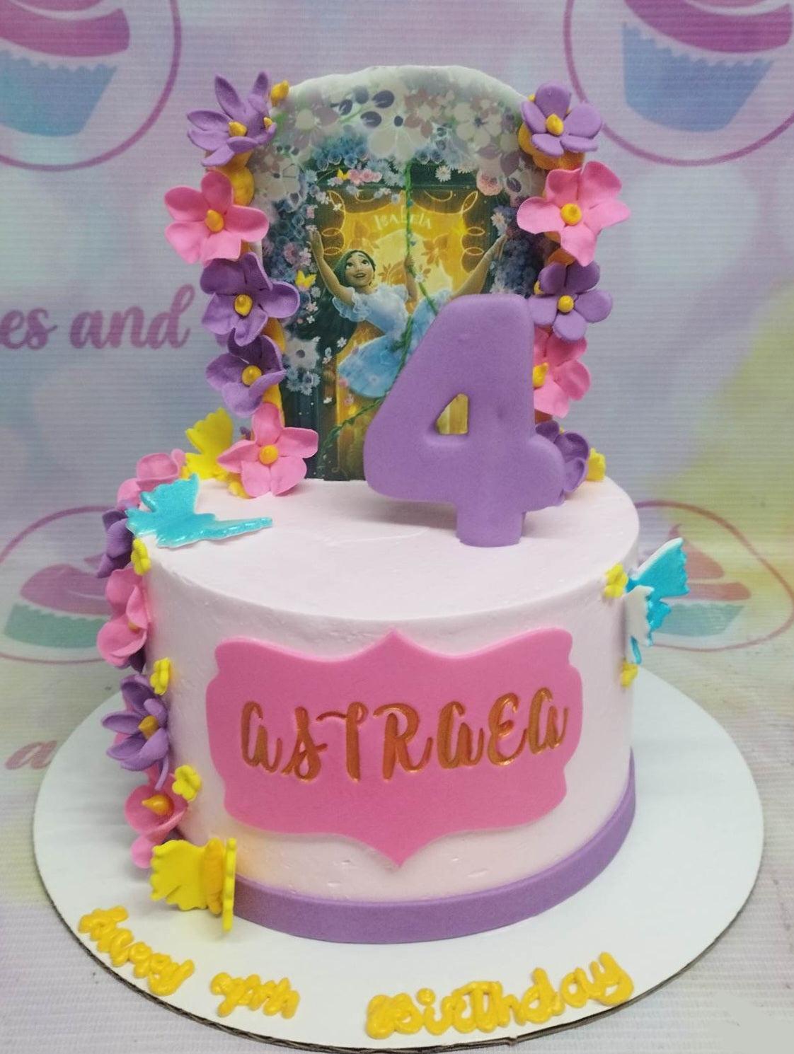 Pink Encanto Isabela themed birthday cake with purple and pink fondant flowers, a large purple number 4, and a character printout.