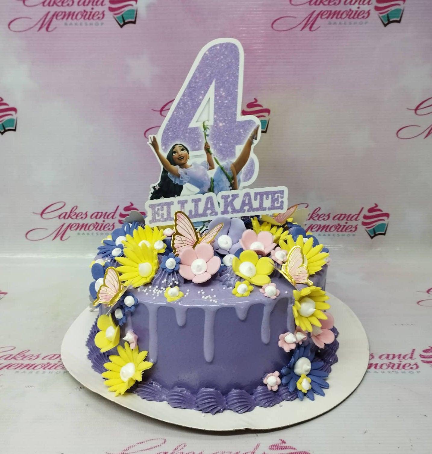 Purple 1-tier Encanto themed birthday cake with Isabela printout topper, fondant flowers, and butterflies.