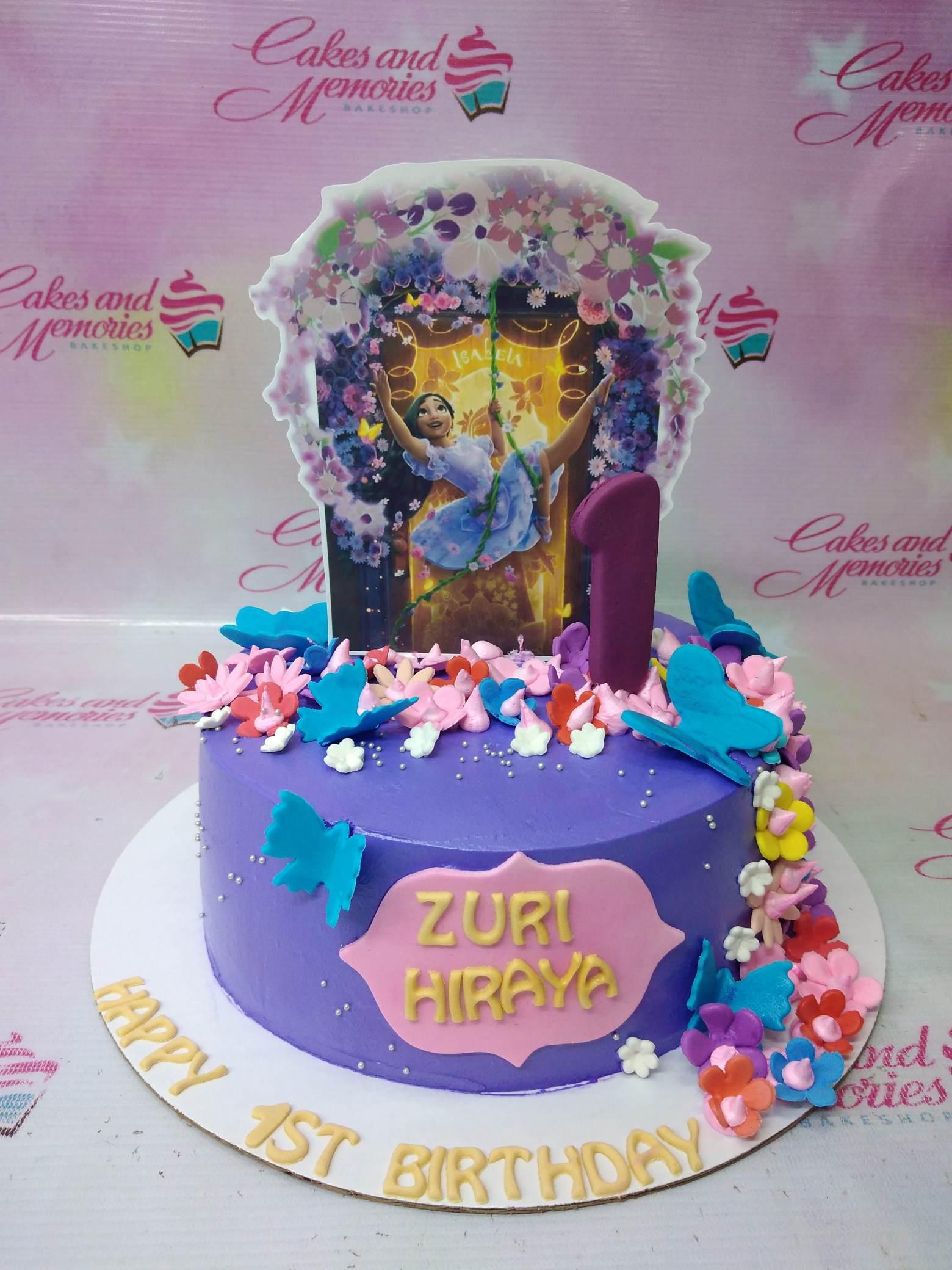 Purple Encanto Isabela themed birthday cake with colorful fondant flowers and butterflies