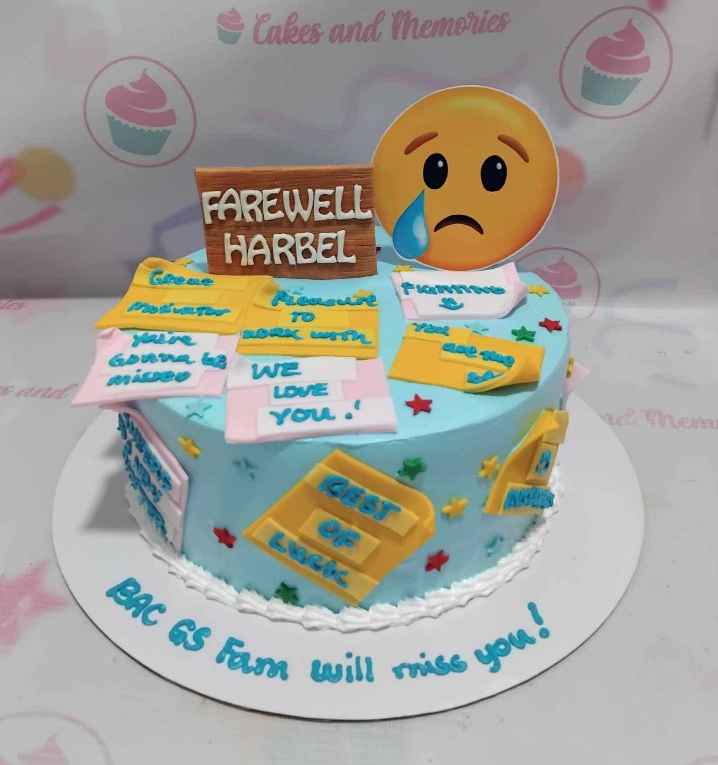 Light blue farewell cake with yellow and pink fondant sticky notes, a crying emoji printout, and a wooden-style farewell sign.