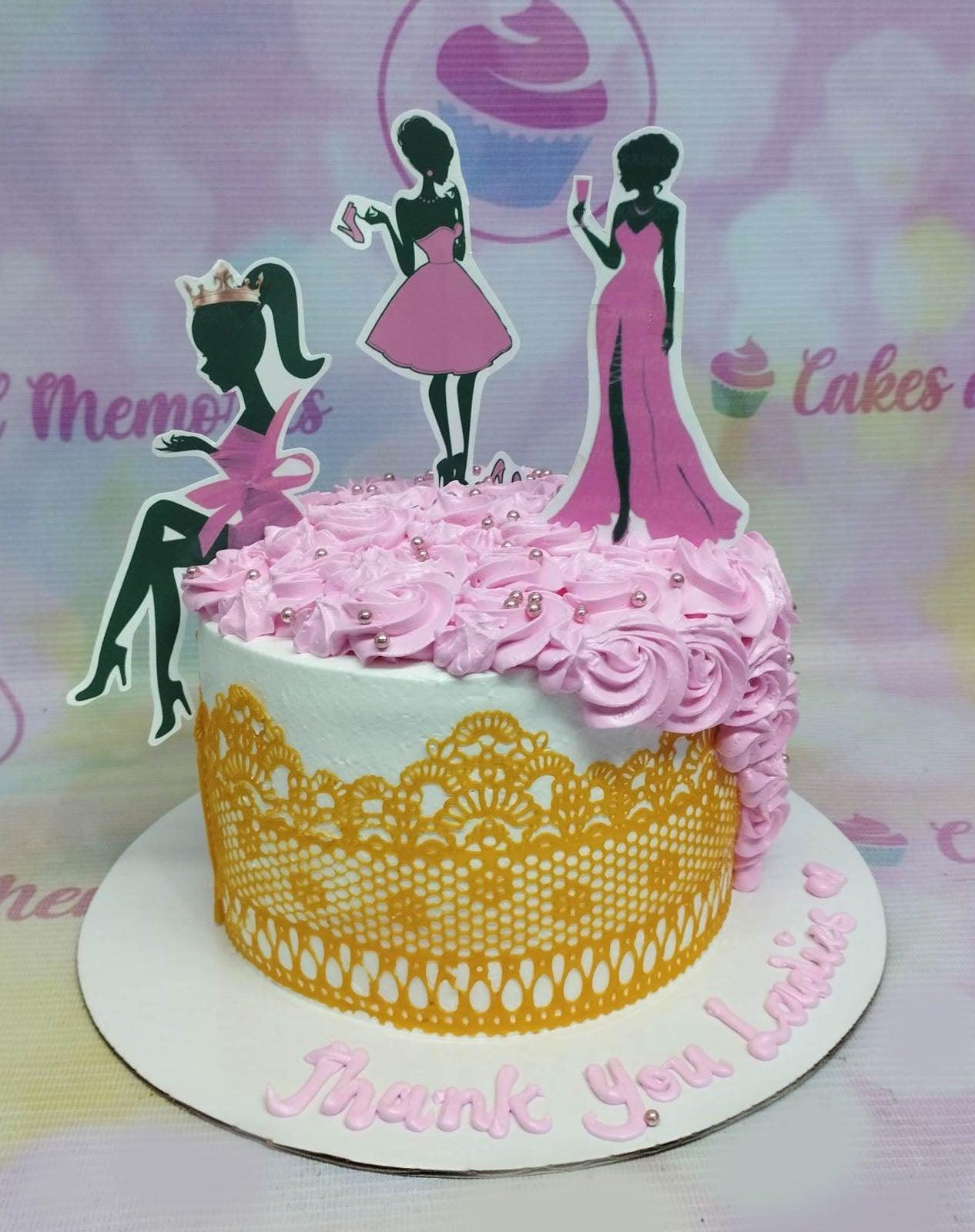 White single tier cake with pink icing rosettes, gold lace gumpaste panel, and fashion lady printout toppers.