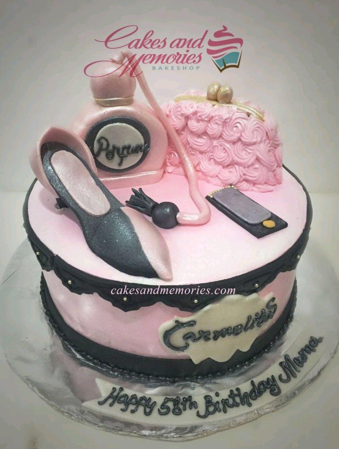 Pink fondant cake with 3D edible perfume bottle, purse, high heel shoe, and makeup accessories for a 58th birthday.