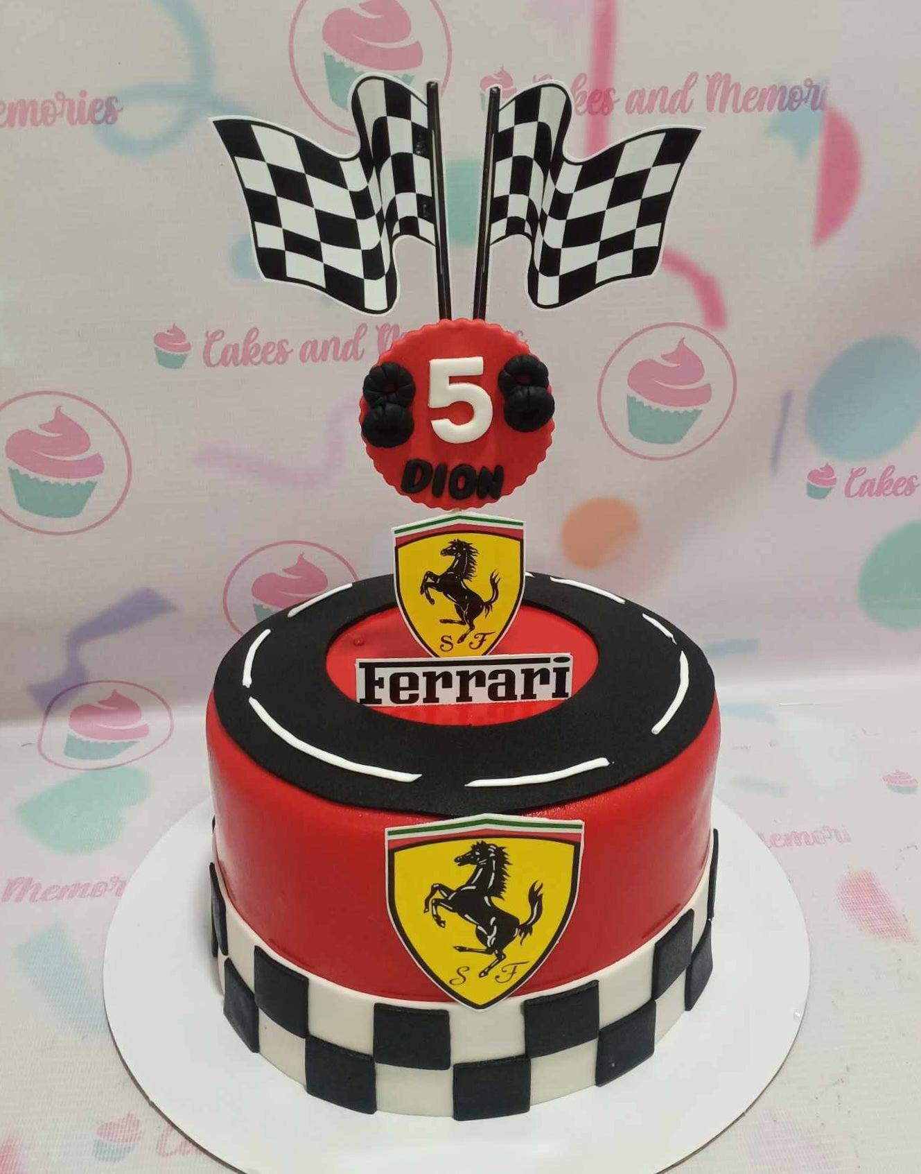 Red Ferrari themed birthday cake with checkered racing flags, a race track top, and Ferrari logo printouts.