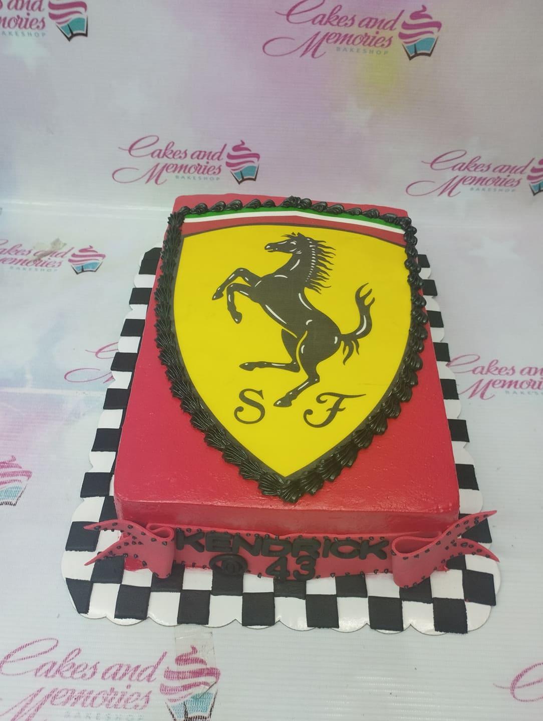 Red Ferrari themed rectangle cake with a large yellow shield logo and black checkered board base.