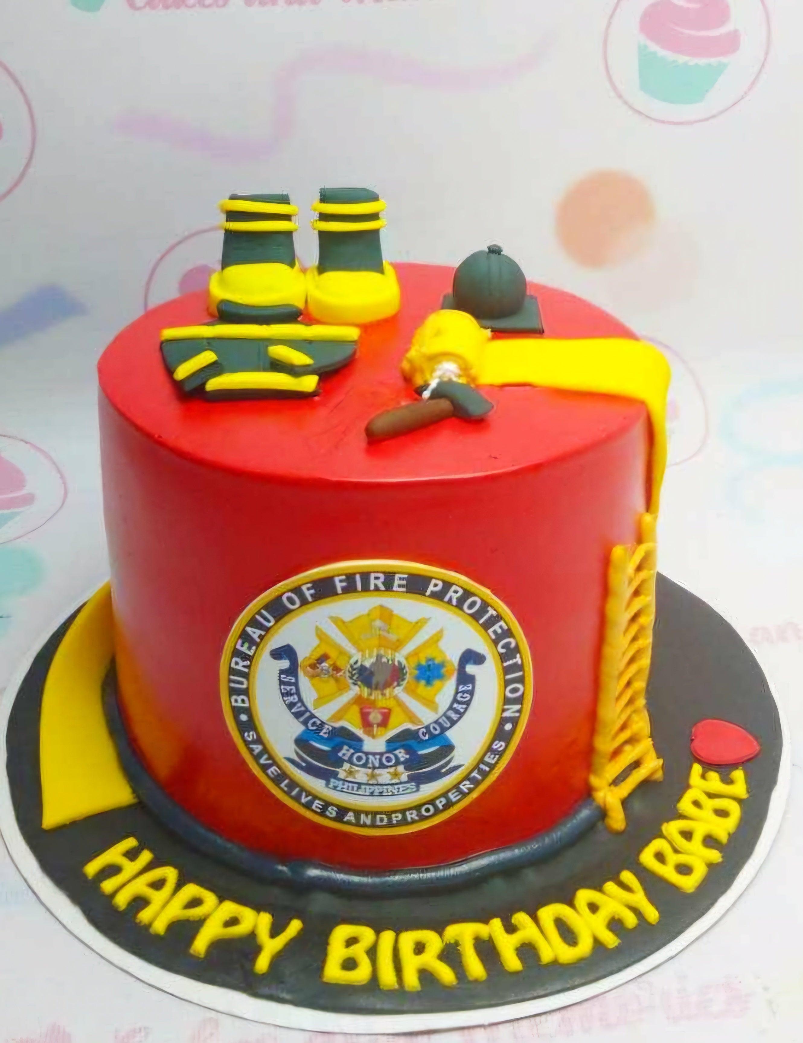 Red firefighter themed birthday cake with fondant fire gear, a yellow ladder, and the Bureau of Fire Protection logo.
