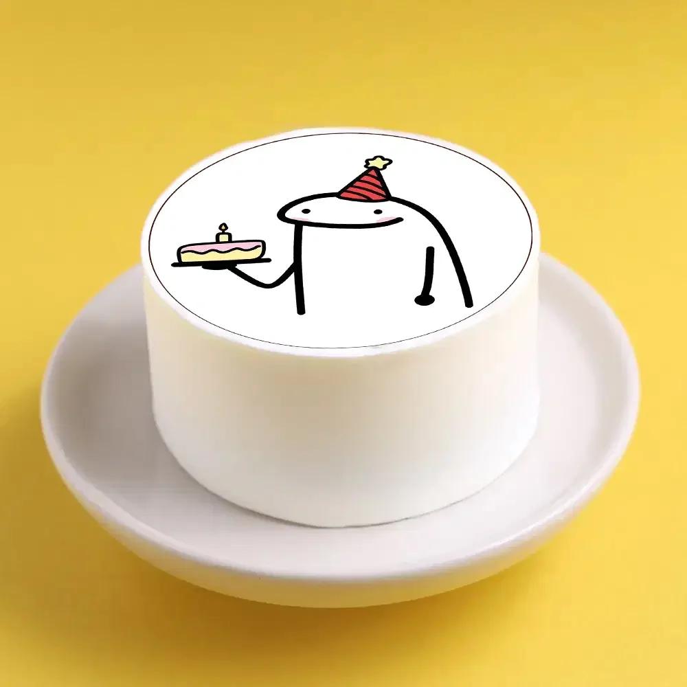 White bento cake featuring a Flork character printout wearing a red party hat and holding a small cake.