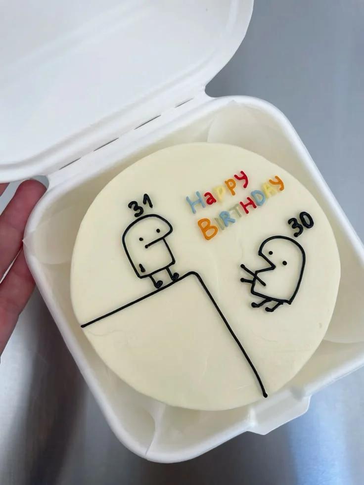 White bento cake with minimalist Flork character doodles and colorful Happy Birthday message.