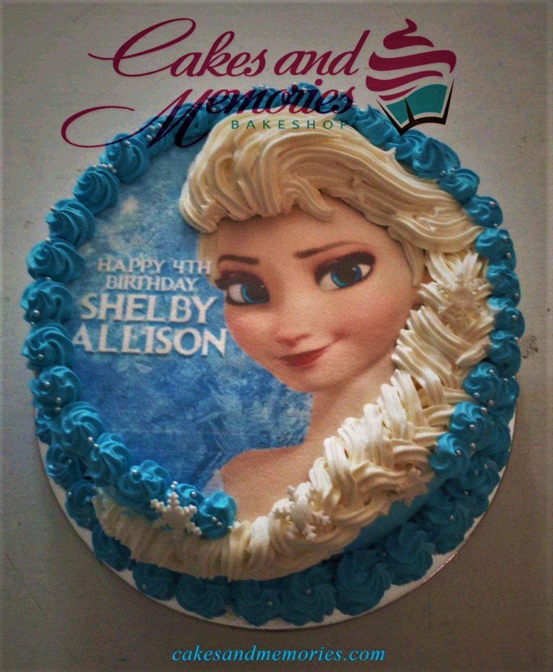 Frozen Elsa themed birthday cake with blue and white icing rosettes and a large Elsa printout for Shelby Allison's 4th birthday.