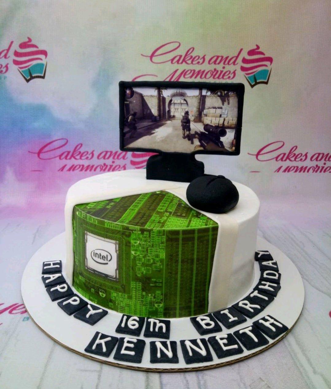 Gaming themed birthday cake with a computer monitor topper showing a first-person shooter game and a green circuit board design on the side.