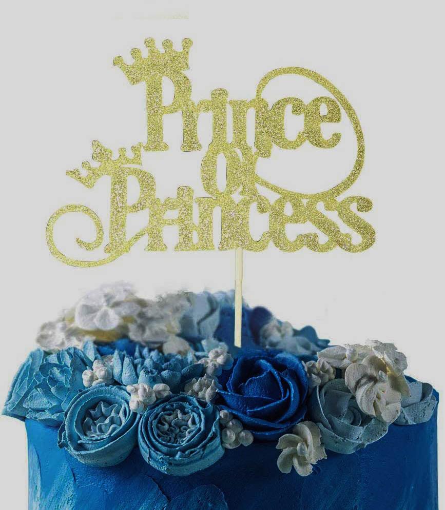 Blue and white floral cake with a gold glitter Prince or Princess gender reveal topper.