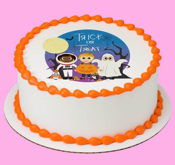 White round cake with orange piped borders and a circular Halloween trick or treat printout featuring an astronaut, pumpkin, and ghost.