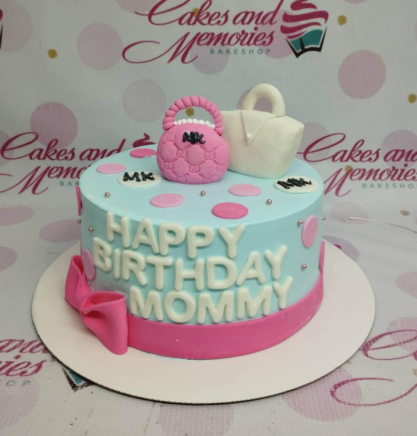 Light blue birthday cake for Mommy featuring pink and white fondant handbags, pink polka dots, and silver dragees.