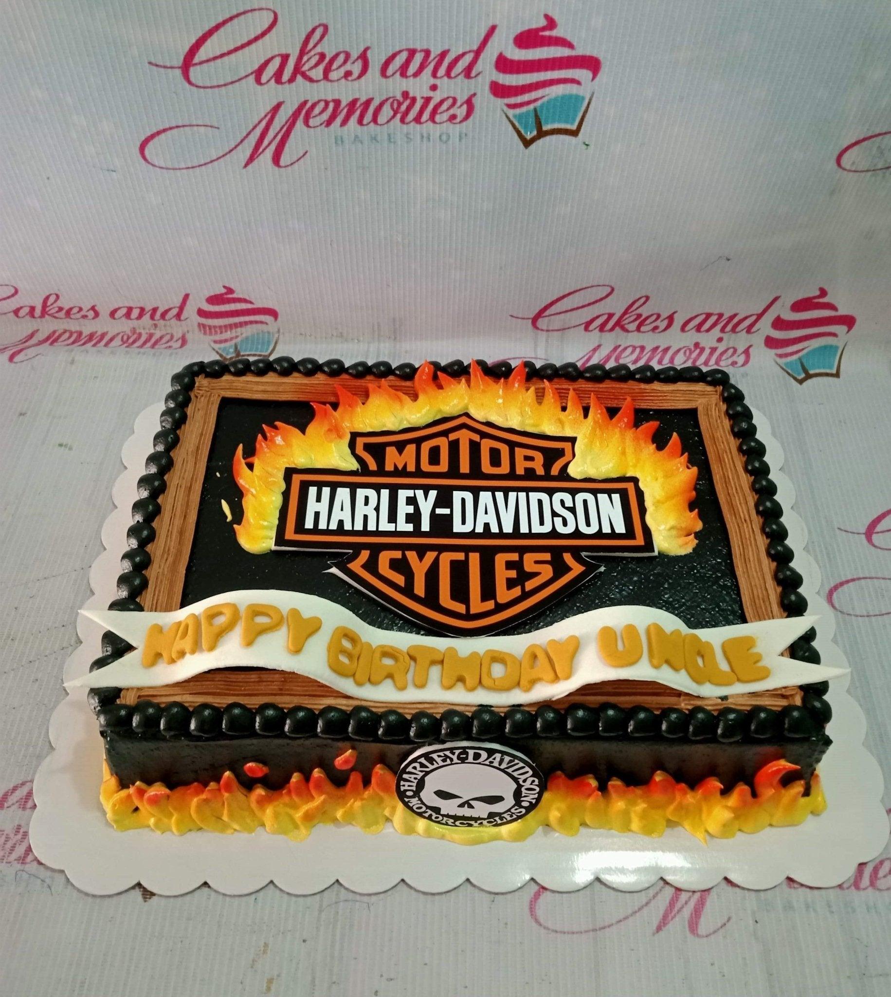 Harley-Davidson themed rectangle cake with black icing, wood-grain border, and edible flame decorations.