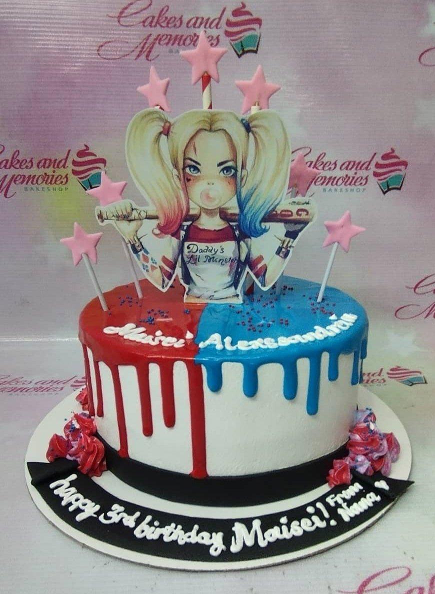 Harley Quinn themed birthday cake with red and blue drip icing, pink star toppers, and a character printout.