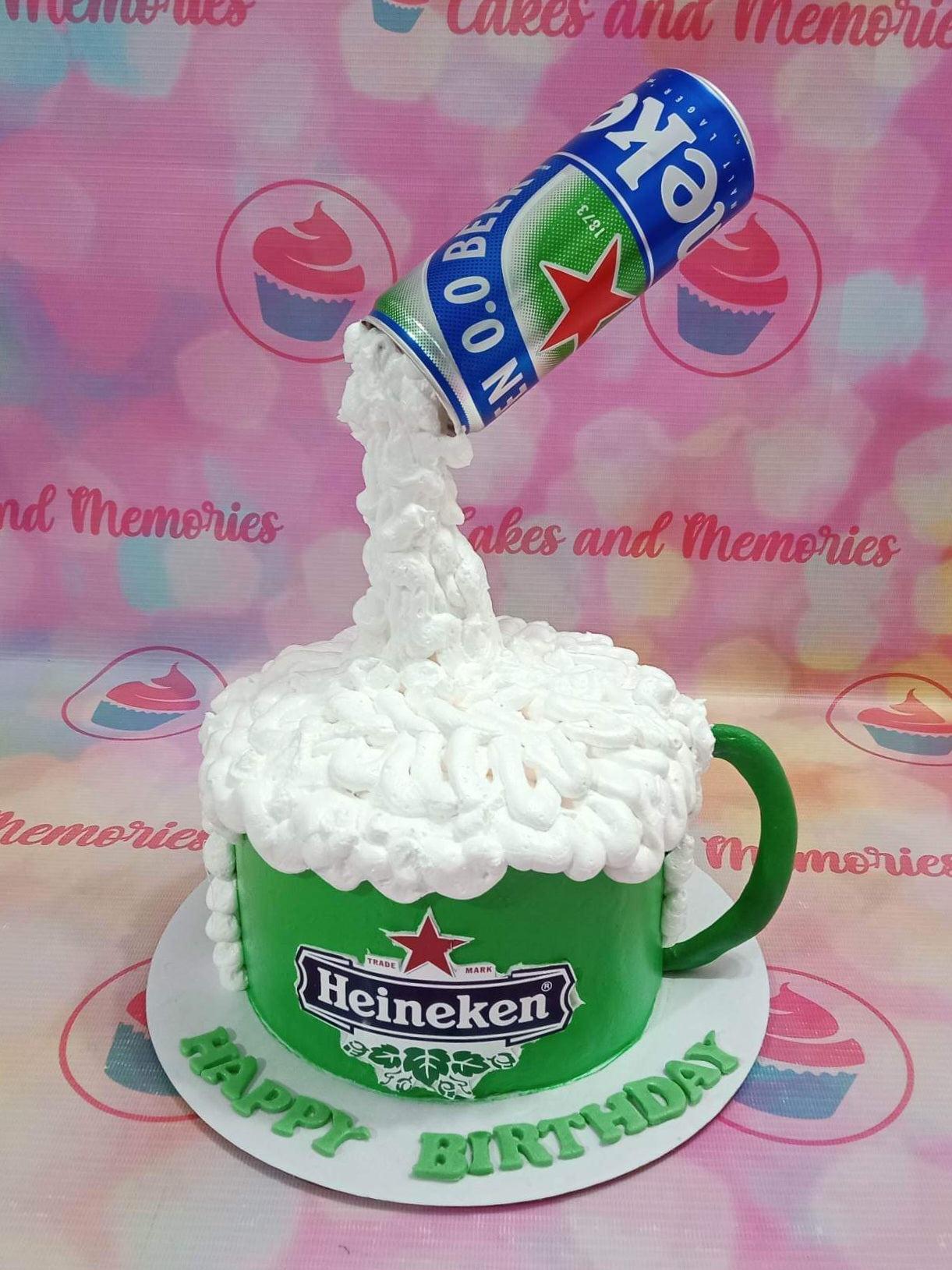 Green Heineken beer mug cake with white icing foam and a suspended beer can topper