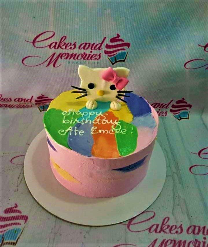 Pink 1-tier Hello Kitty birthday cake with colorful palette knife icing strokes and a fondant Hello Kitty topper.