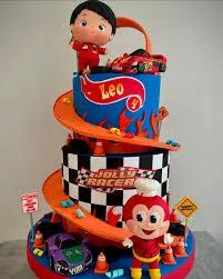Two-tier Hot Wheels and Jollibee themed birthday cake with orange racing tracks, checkered patterns, and 3D character figures.