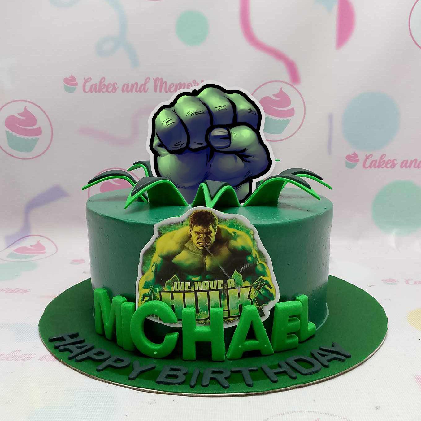Green Hulk themed birthday cake with a large fist topper and character printout for Michael's birthday.