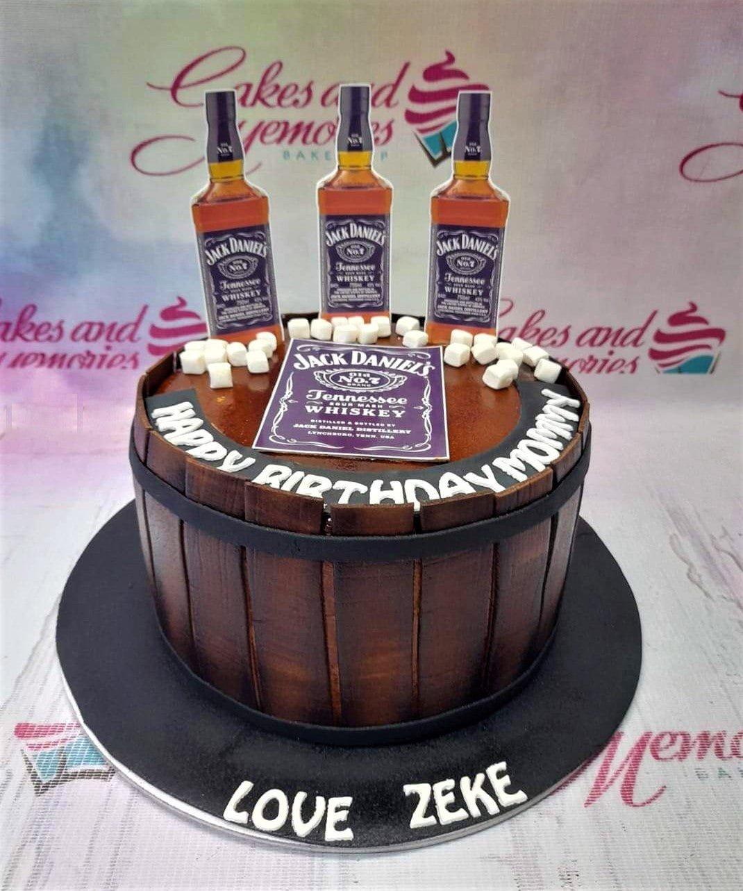 Jack Daniel's whiskey barrel cake with printed bottle toppers and marshmallow ice cubes