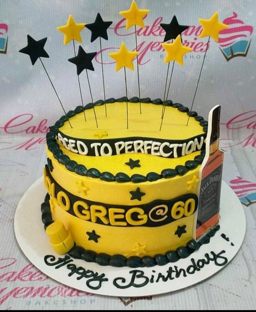 Yellow and black Jack Daniels themed birthday cake with star toppers and 'Aged to Perfection' message.