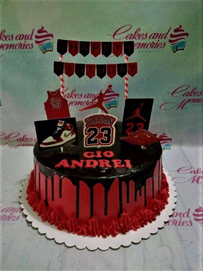 Black and red Jordan basketball themed cake with chocolate drip and printed toppers