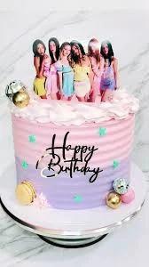 A single tier purple and pink gradient cake with a K-pop group printout topper and gold disco ball accents.