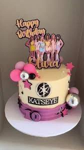 Katseye K-pop themed birthday cake for Olivia with pink and purple accents, stars, and musical notes.