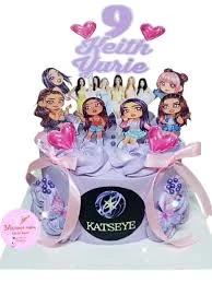 Purple Katseye themed birthday cake with character printouts, pink heart balloons, and a large purple number 9 topper.