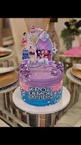 Purple, pink, and blue gradient K-Pop Demon Hunters themed cake with character printouts and purple icing swirls.