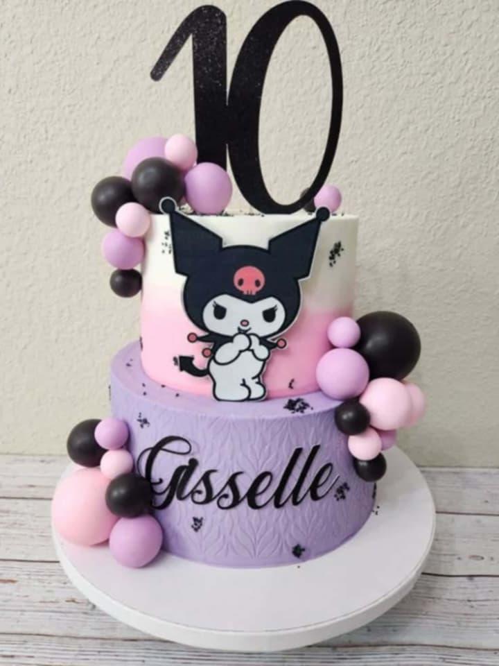 Two-tier purple and pink Kuromi themed cake with black and pink decorative balls and a large number 10 topper