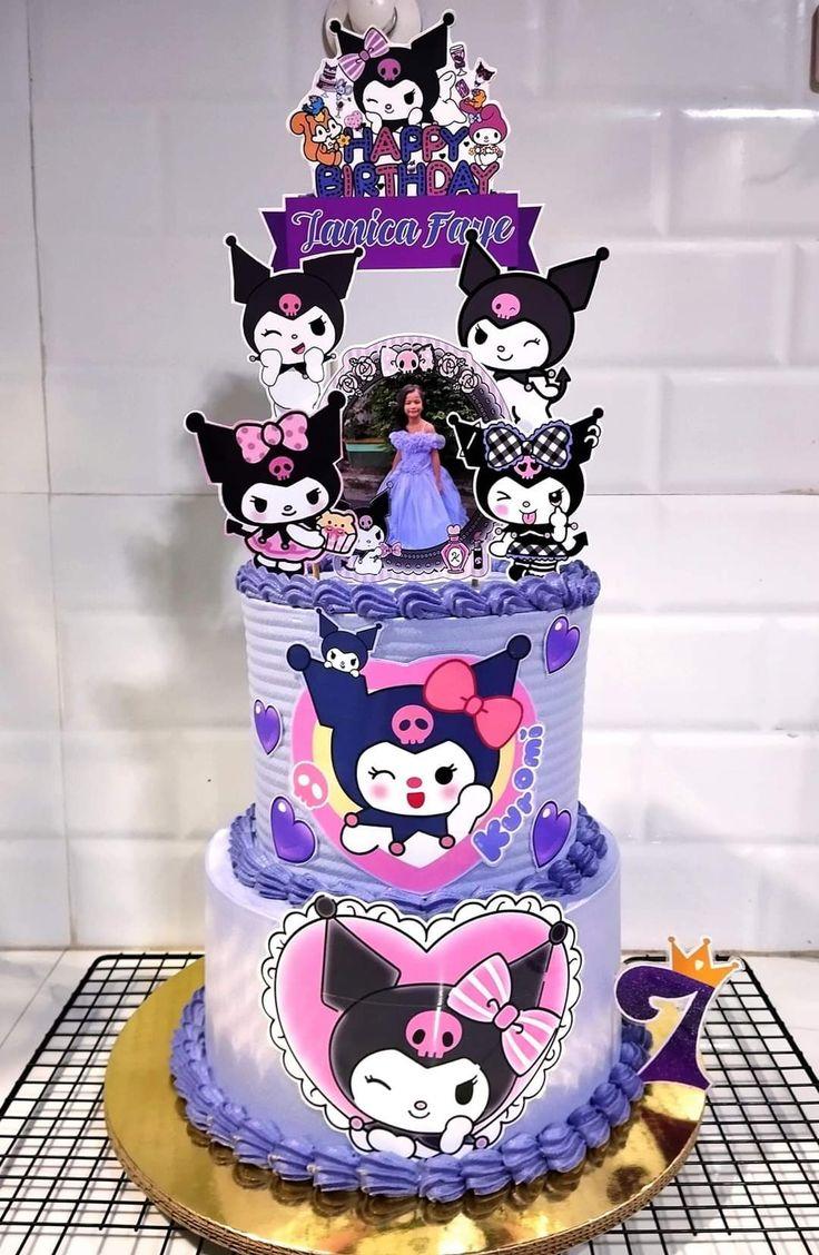 Two-tier lavender Kuromi themed cake with character printouts and purple icing borders