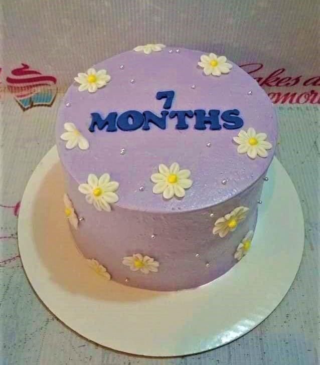 Lavender minimalist cake with white fondant daisies and blue gumpaste letters reading 7 MONTHS