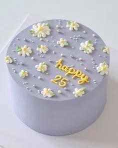 Minimalist lavender bento cake with piped white daisies and yellow Happy 25 message