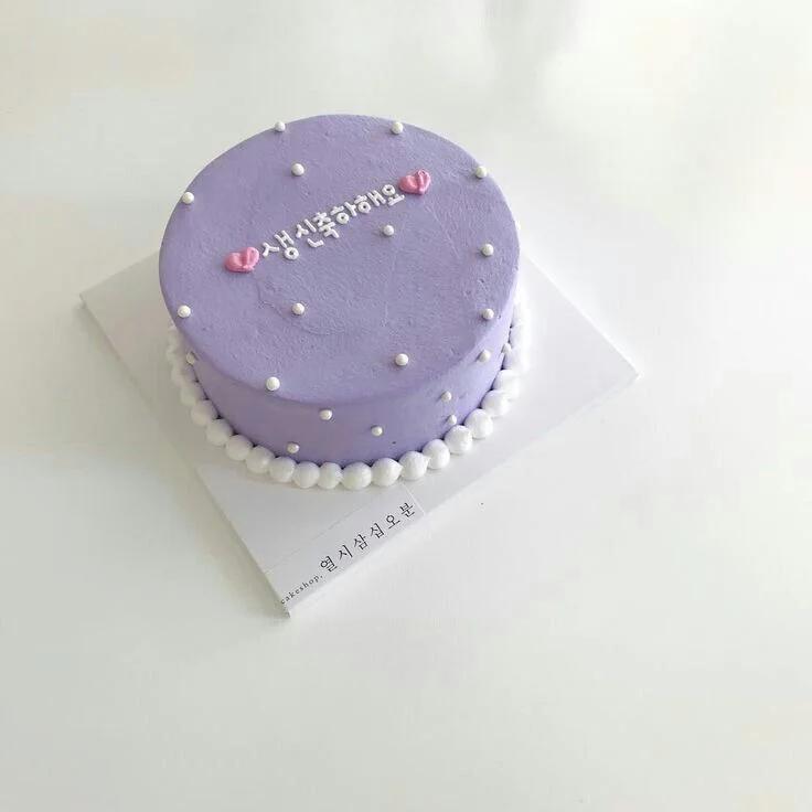 Minimalist lavender bento cake with white pearl sprinkles and Korean birthday message in white icing.