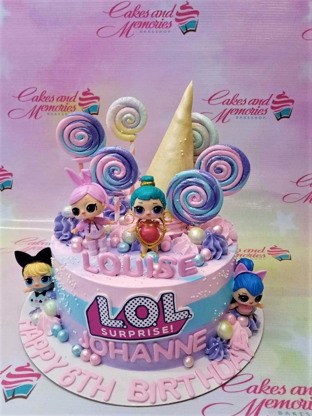 LOL Surprise themed birthday cake with pink and blue gradient icing, lollipop toppers, and character figurines.