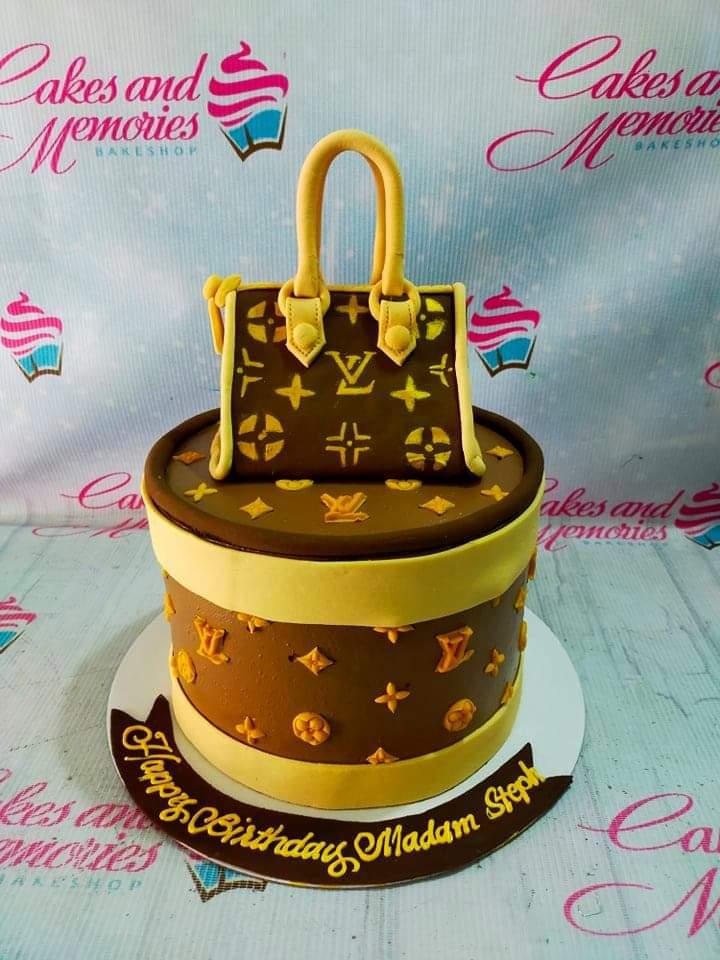 Brown Louis Vuitton designer bag themed cake with yellow accents and a matching fondant handbag topper.