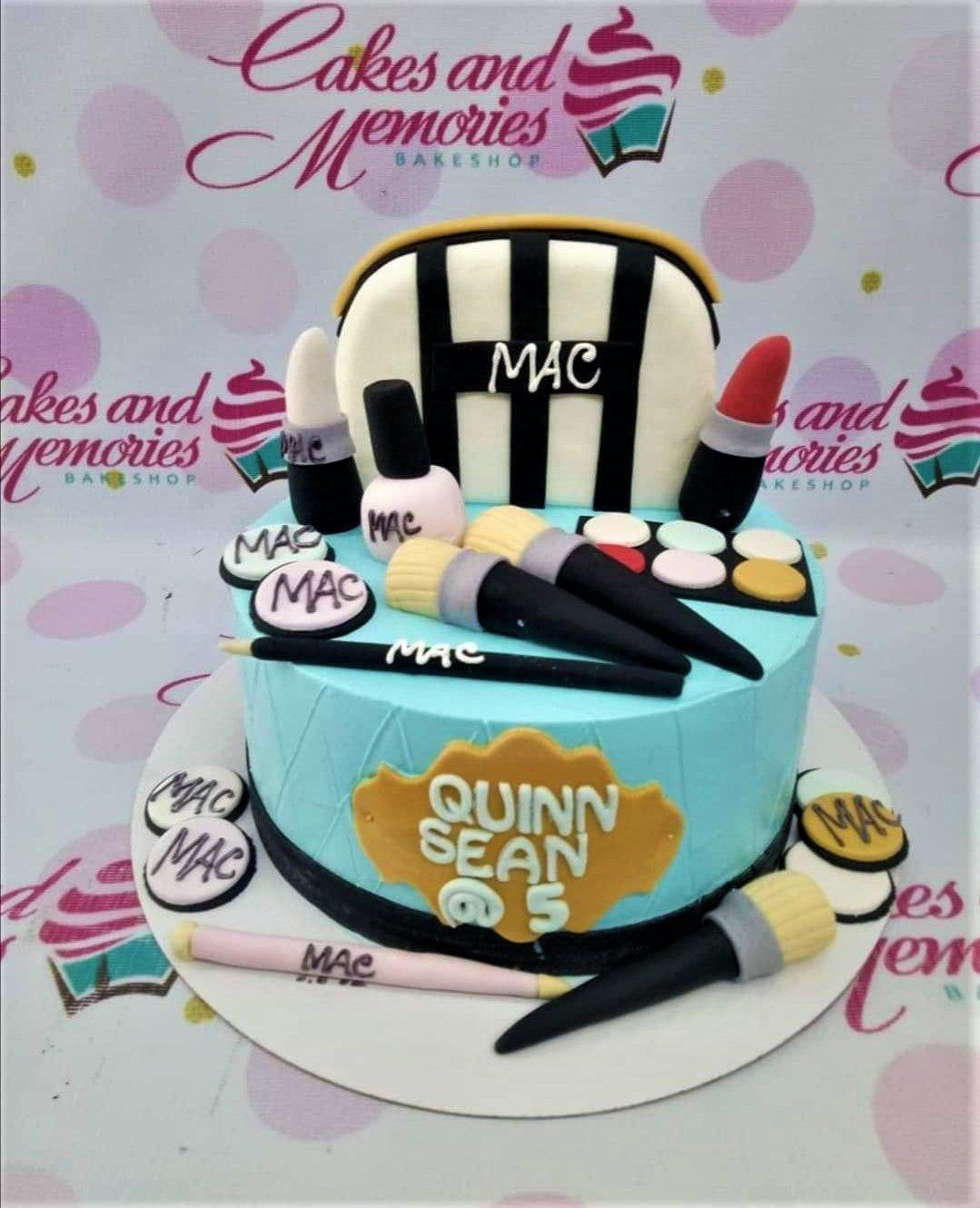 Light blue fondant cake with MAC makeup toppers including lipstick, brushes, and eyeshadow palette for a 5th birthday celebration.