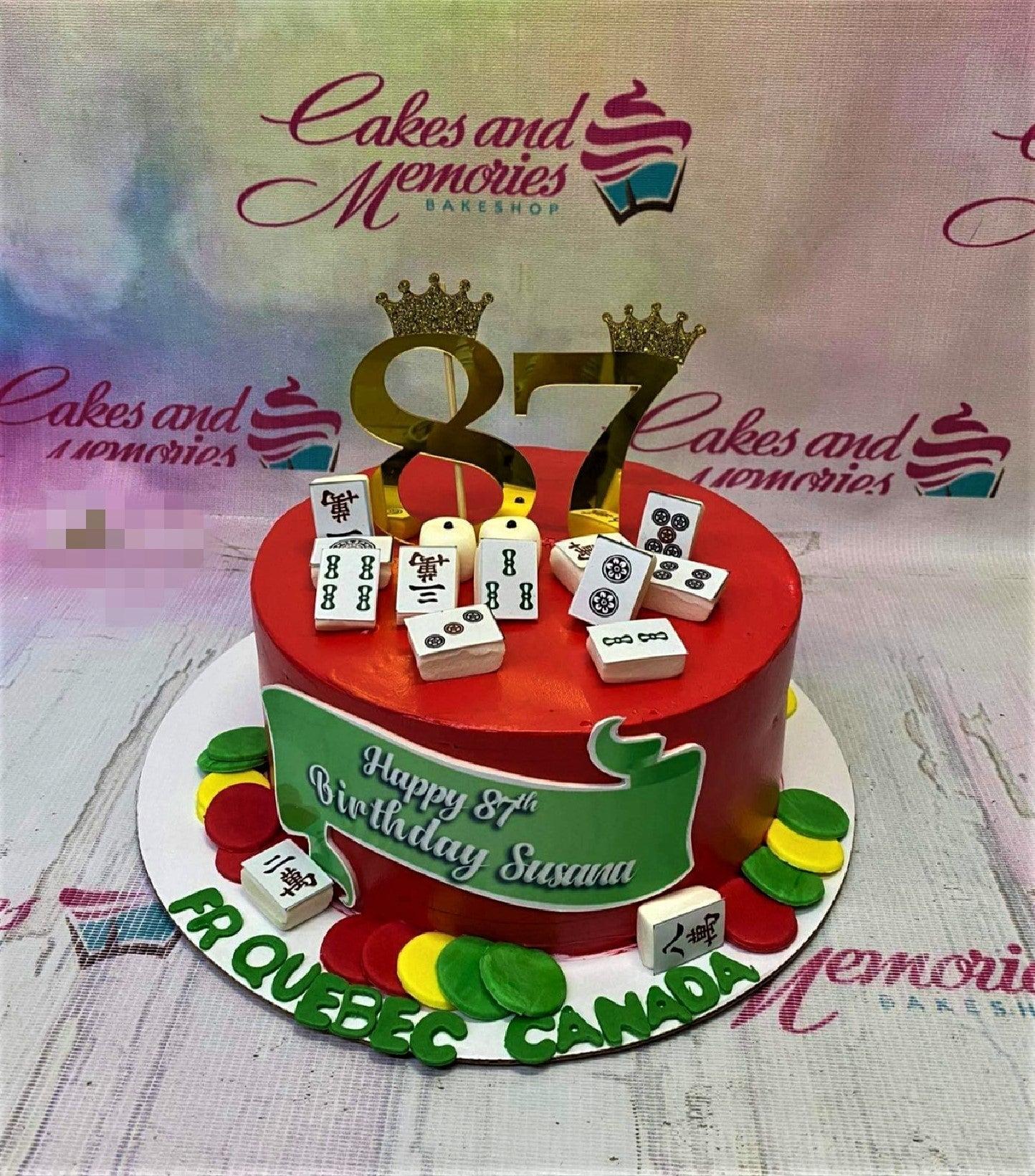 Red mahjong themed birthday cake with gold 87 toppers and edible mahjong tiles