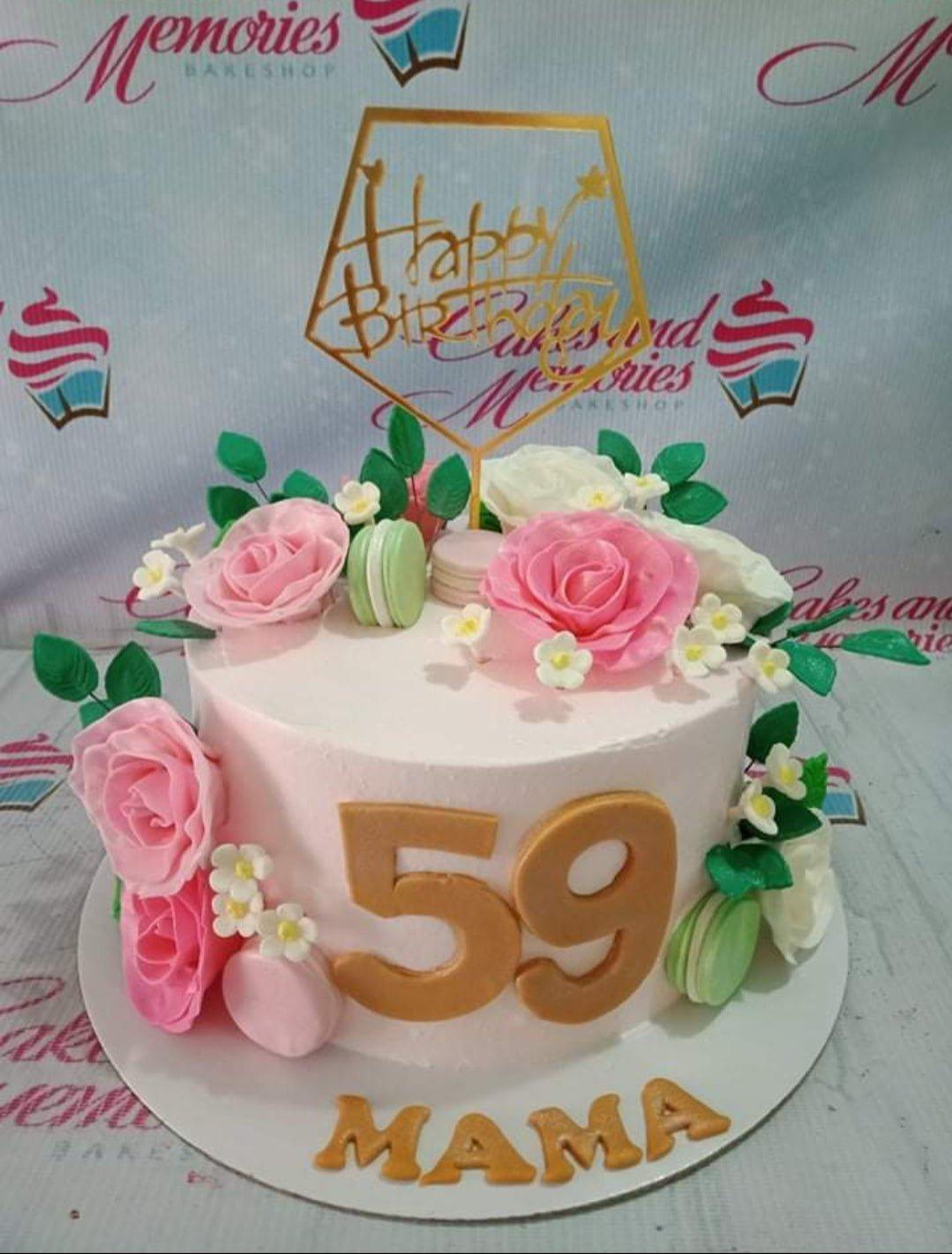 Light pink 1-tier birthday cake for Mama's 59th birthday featuring pink and white edible roses, green macarons, and gold number toppers.