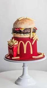 McDonald's themed red fondant cake with a large 3D burger topper and fondant french fries.