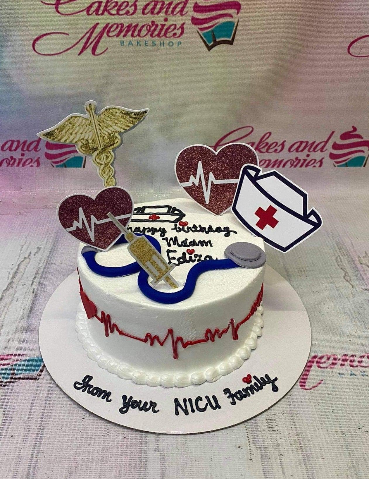 White medical themed birthday cake with stethoscope, syringe, and nurse hat toppers for a NICU family celebration.