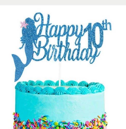Light blue mermaid birthday cake with a glittery blue mermaid topper and colorful sprinkles at the base.