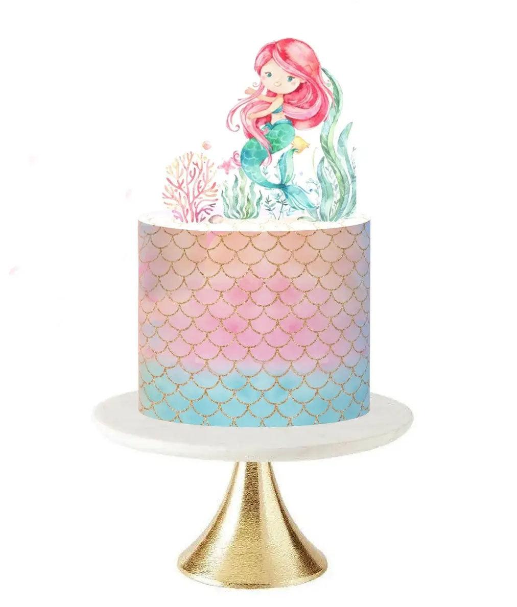 Mermaid themed birthday cake with watercolor mermaid and coral printouts on a pastel scale patterned icing base.