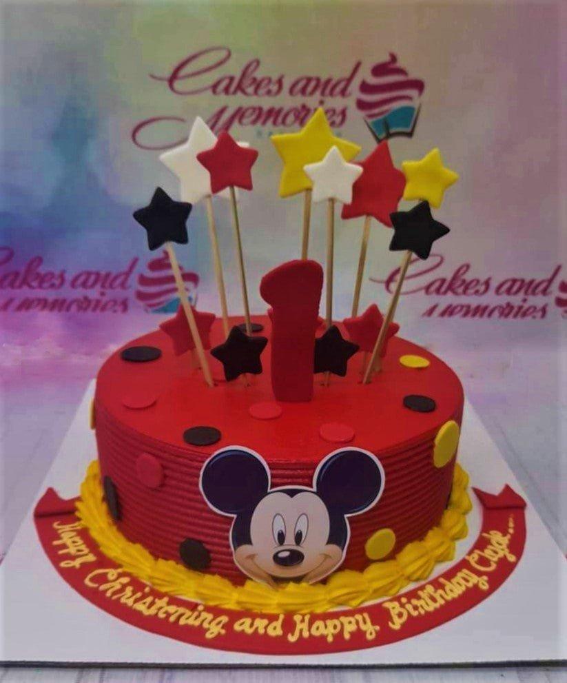 Red Mickey Mouse themed birthday and christening cake with star toppers and yellow icing border.