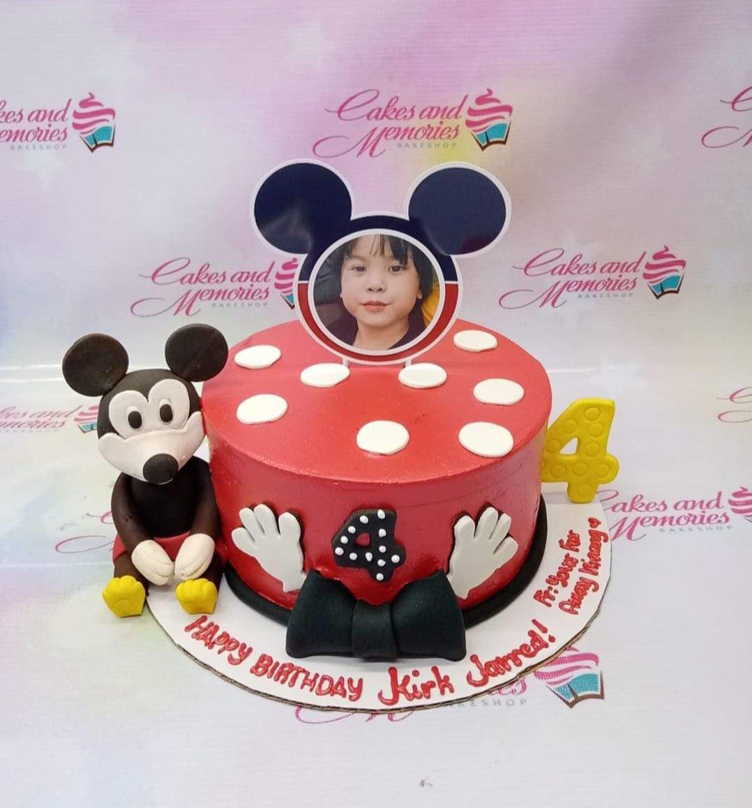 Red Mickey Mouse themed birthday cake with white polka dots, a 3D Mickey figure, and a personalized photo topper for Kirk Jarred's 4th birthday.