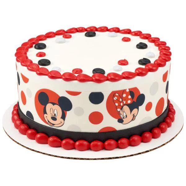Mickey and Minnie Mouse themed birthday cake with red icing borders and polka dot side wrap
